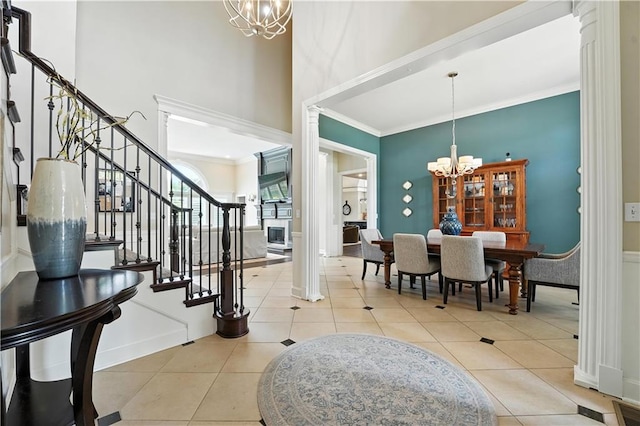 9905 W 144th St, Overland Park, KS 66221 - tiled foyer with a chandelier, ornamental molding, stairway, a towering ceiling, and ornate columns