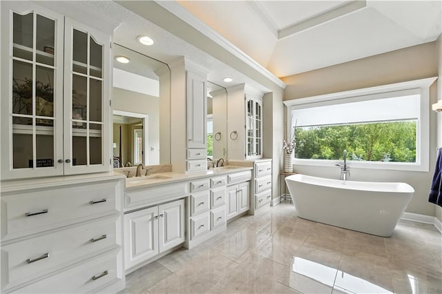 9905 W 144th St, Overland Park, KS 66221 - bathroom with double vanity, a freestanding tub, and recessed lighting