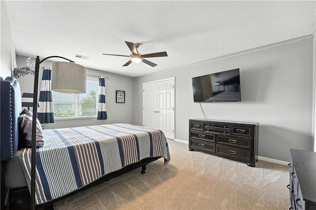 9905 W 144th St, Overland Park, KS 66221 - bedroom featuring light colored carpet, a closet, a ceiling fan, and a textured ceiling
