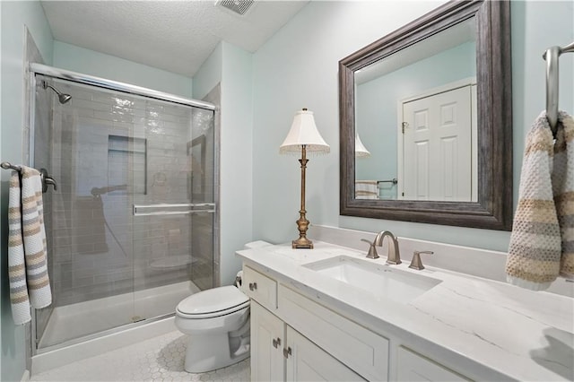9905 W 144th St, Overland Park, KS 66221 - bathroom featuring vanity, a shower stall, a textured ceiling, and tile patterned flooring