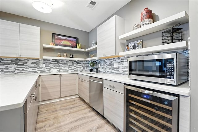 9905 W 144th St, Overland Park, KS 66221 - kitchen with open shelves, wine cooler, appliances with stainless steel finishes, and backsplash