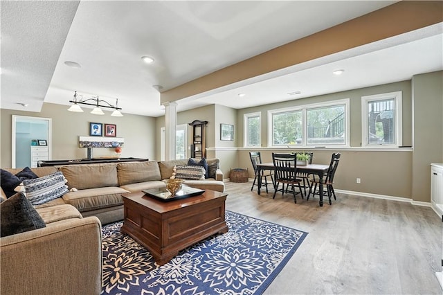 9905 W 144th St, Overland Park, KS 66221 - living room with ornate columns, wood finished floors, and recessed lighting