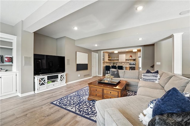 9905 W 144th St, Overland Park, KS 66221 - living area with light wood finished floors, recessed lighting, and built in shelves