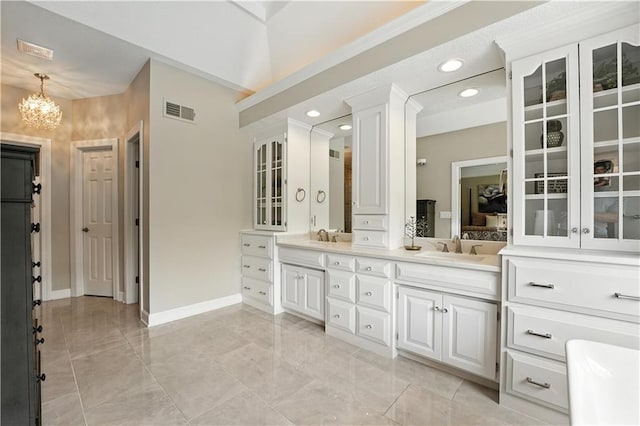 9905 W 144th St, Overland Park, KS 66221 - bathroom featuring double vanity, a chandelier, recessed lighting, and marble finish floors