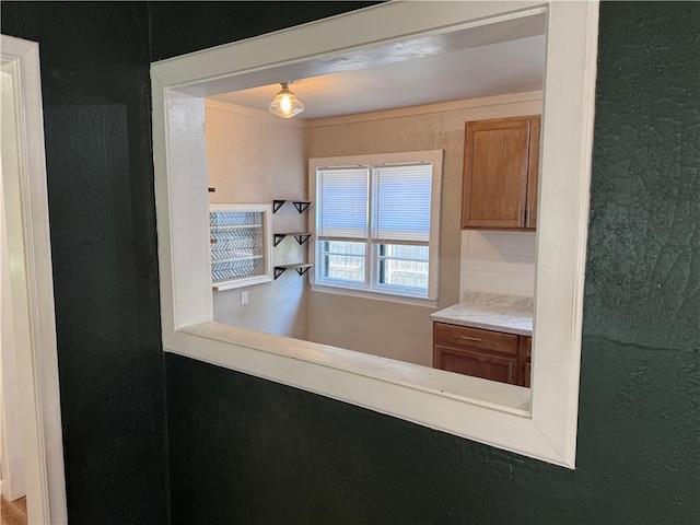 612 W Walnut St, Independence, KS 67301 - kitchen with brown cabinets, light countertops, and a textured wall