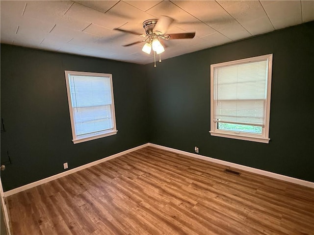 612 W Walnut St, Independence, KS 67301 - spare room featuring wood finished floors and ceiling fan