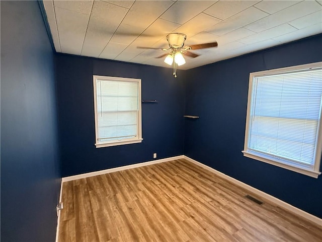 612 W Walnut St, Independence, KS 67301 - empty room with a ceiling fan, wood finished floors, plenty of natural light, and baseboards