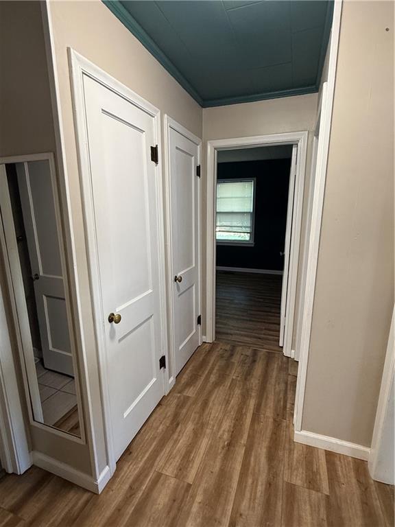 612 W Walnut St, Independence, KS 67301 - hallway with wood finished floors and baseboards