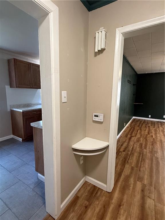 612 W Walnut St, Independence, KS 67301 - hall with baseboards and wood finished floors