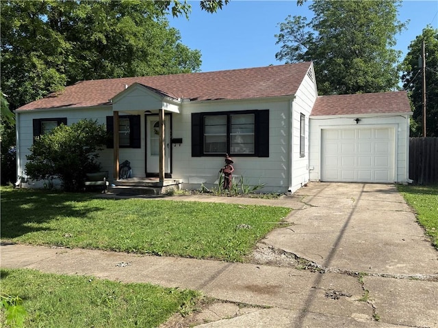 612 W Walnut St, Independence, KS 67301 - bungalow-style house with roof with shingles, concrete driveway, and an attached garage