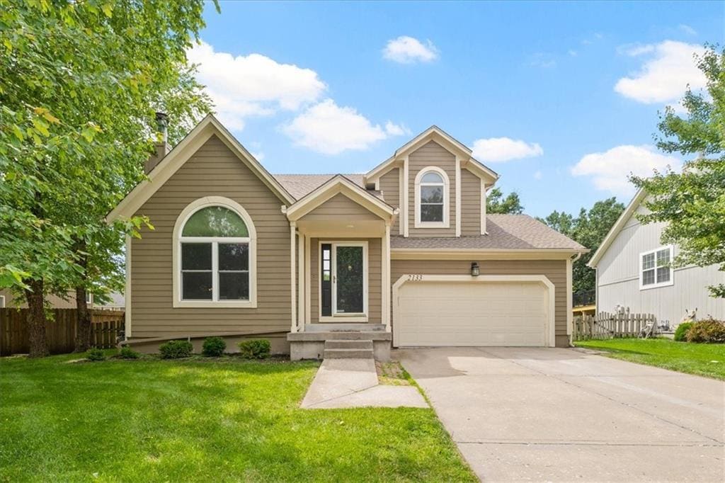2133 S Stagecoach Dr, Olathe, KS 66062 - view of front of property featuring concrete driveway, roof with shingles, and an attached garage