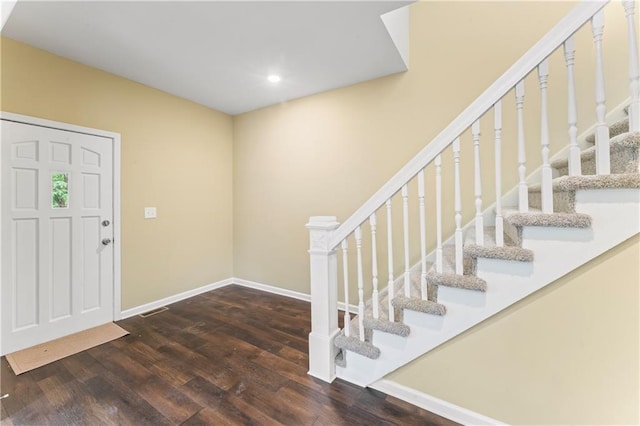 2717 Bales Ave, Kansas City, MO 64128 - entryway with wood finished floors, stairway, and recessed lighting