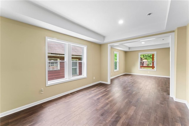 2717 Bales Ave, Kansas City, MO 64128 - spare room with dark wood-style flooring and a tray ceiling
