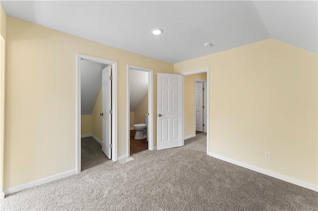 2717 Bales Ave, Kansas City, MO 64128 - unfurnished bedroom featuring carpet, vaulted ceiling, a walk in closet, recessed lighting, and ensuite bathroom