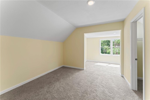2717 Bales Ave, Kansas City, MO 64128 - additional living space featuring carpet floors, vaulted ceiling, and recessed lighting