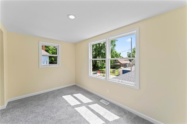 2717 Bales Ave, Kansas City, MO 64128 - carpeted empty room with healthy amount of natural light