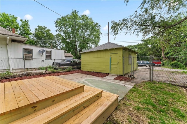 2717 Bales Ave, Kansas City, MO 64128 - wooden deck featuring a gate and an outbuilding