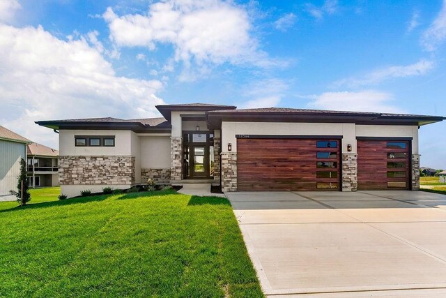 15285 W 162nd St, Olathe, KS 66062 - view of front of home with stone siding, stucco siding, an attached garage, a front lawn, and driveway