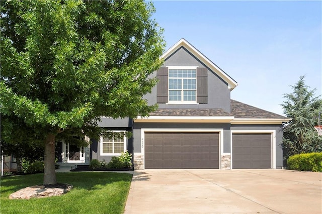 4529 Lakecrest Dr, Shawnee, KS 66218 - view of front of home with stone siding, driveway, an attached garage, and stucco siding