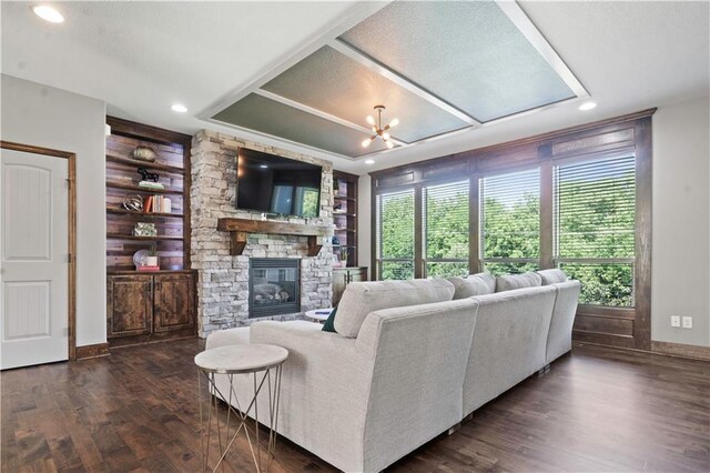 4529 Lakecrest Dr, Shawnee, KS 66218 - living area with a stone fireplace, a chandelier, dark wood-type flooring, recessed lighting, and built in features