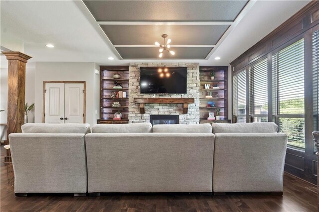 4529 Lakecrest Dr, Shawnee, KS 66218 - living area featuring a stone fireplace, a chandelier, built in shelves, dark wood finished floors, and recessed lighting