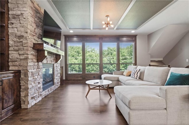 4529 Lakecrest Dr, Shawnee, KS 66218 - living room with a chandelier, healthy amount of natural light, a stone fireplace, and dark wood-style floors