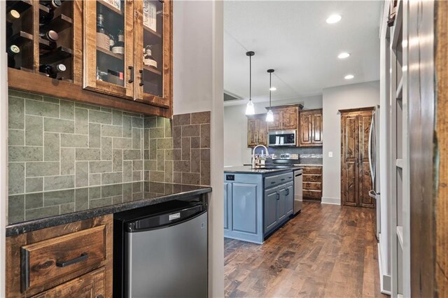 4529 Lakecrest Dr, Shawnee, KS 66218 - kitchen featuring appliances with stainless steel finishes, tasteful backsplash, glass insert cabinets, dark wood-type flooring, and recessed lighting