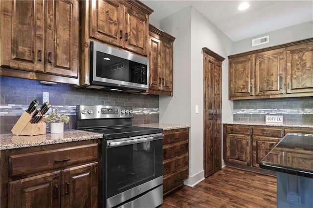 4529 Lakecrest Dr, Shawnee, KS 66218 - kitchen featuring stainless steel appliances, dark wood-type flooring, decorative backsplash, light stone counters, and recessed lighting