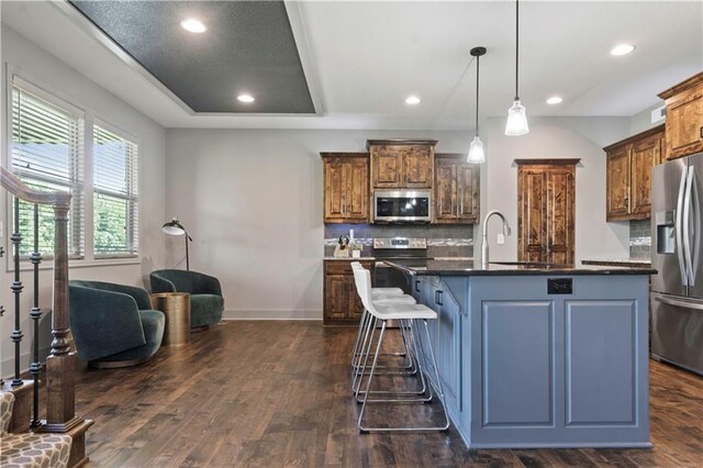 4529 Lakecrest Dr, Shawnee, KS 66218 - kitchen with stainless steel appliances, dark countertops, dark wood-type flooring, backsplash, and recessed lighting