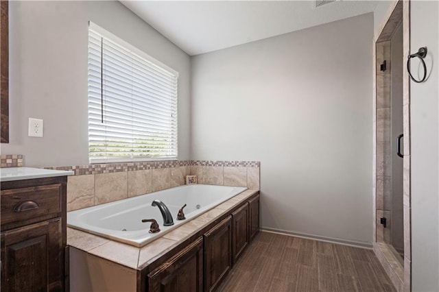 4529 Lakecrest Dr, Shawnee, KS 66218 - full bath featuring a jetted tub, a stall shower, vanity, and wood finished floors