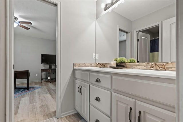4529 Lakecrest Dr, Shawnee, KS 66218 - full bath featuring double vanity, tasteful backsplash, a ceiling fan, and wood finished floors