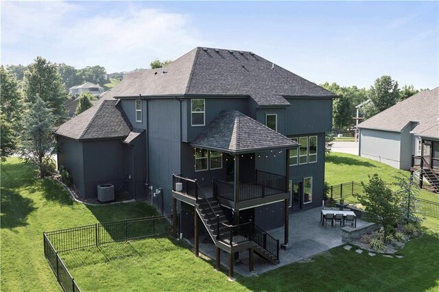 4529 Lakecrest Dr, Shawnee, KS 66218 - back of property featuring stairway, roof with shingles, a patio, and a fenced backyard