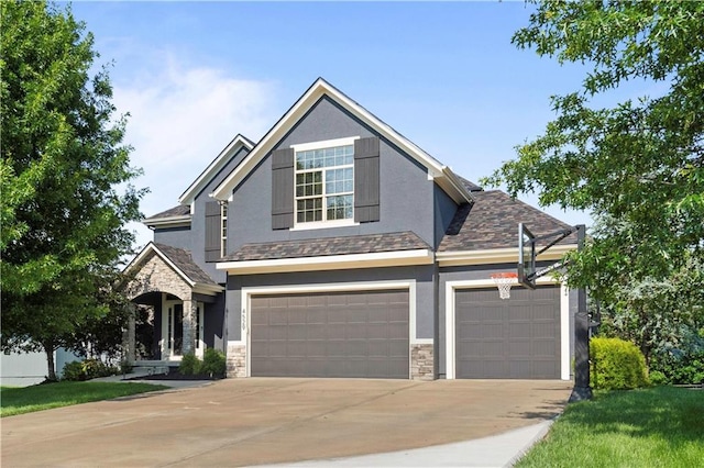 4529 Lakecrest Dr, Shawnee, KS 66218 - view of front of home with stone siding, stucco siding, concrete driveway, and a garage