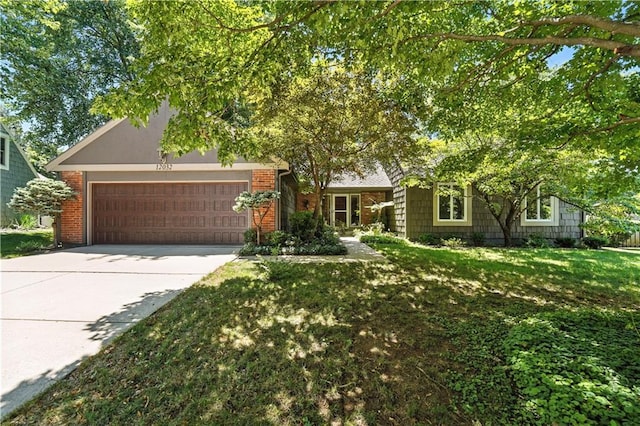 12032 Ballentine St, Overland Park, KS 66213 - view of front of house featuring a garage, concrete driveway, a front lawn, and brick siding