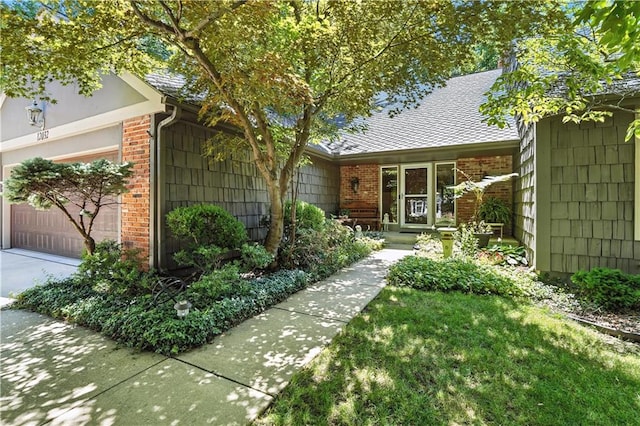 12032 Ballentine St, Overland Park, KS 66213 - view of front of home with brick siding, an attached garage, and a shingled roof