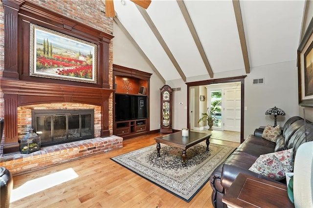12032 Ballentine St, Overland Park, KS 66213 - living area with beam ceiling, high vaulted ceiling, wood finished floors, a fireplace, and a ceiling fan