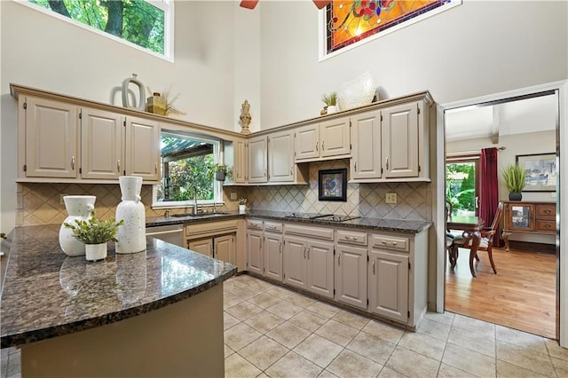 12032 Ballentine St, Overland Park, KS 66213 - kitchen featuring a towering ceiling, light tile patterned floors, plenty of natural light, and cooktop