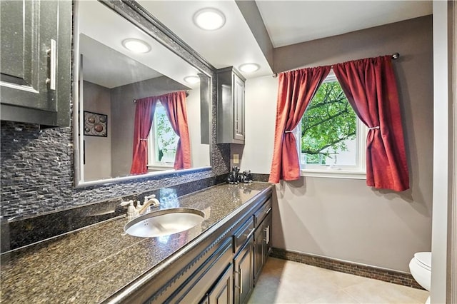 12032 Ballentine St, Overland Park, KS 66213 - bathroom featuring vanity, tile patterned floors, and tasteful backsplash