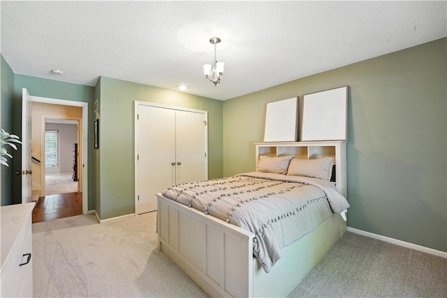 12032 Ballentine St, Overland Park, KS 66213 - bedroom with light colored carpet, a closet, and a chandelier