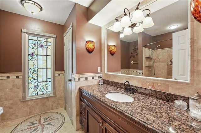 12032 Ballentine St, Overland Park, KS 66213 - bathroom with tile walls, vanity, tile patterned floors, wainscoting, and tiled shower