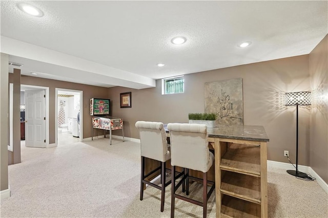 12032 Ballentine St, Overland Park, KS 66213 - dining space with light colored carpet, a textured ceiling, recessed lighting, and washer / dryer
