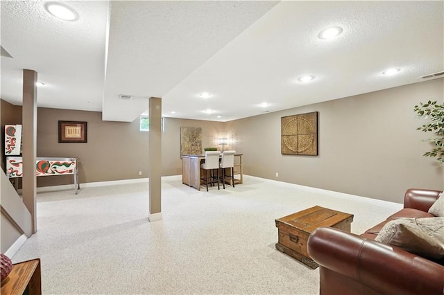 12032 Ballentine St, Overland Park, KS 66213 - living room featuring a textured ceiling, a bar, recessed lighting, and carpet floors