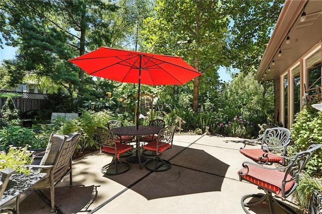 12032 Ballentine St, Overland Park, KS 66213 - view of patio / terrace featuring outdoor dining space and view of scattered trees