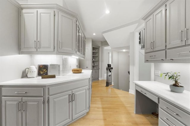 6205 W 149th St, Overland Park, KS 66223 - kitchen featuring gray cabinetry, light wood-style flooring, light countertops, tasteful backsplash, and recessed lighting