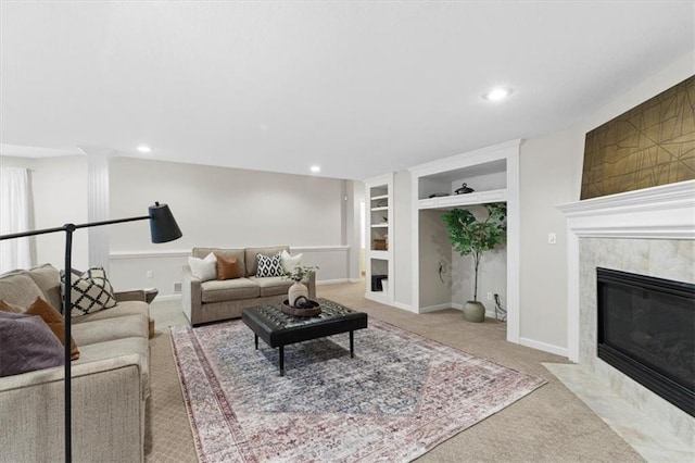6205 W 149th St, Overland Park, KS 66223 - carpeted living area featuring built in shelves, a premium fireplace, recessed lighting, and ornate columns