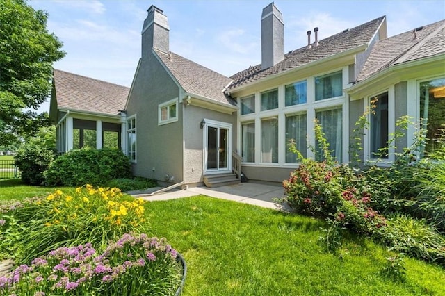 6205 W 149th St, Overland Park, KS 66223 - rear view of property with entry steps, stucco siding, a patio area, and a yard