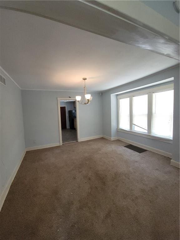 5000 Agnes Ave, Kansas City, MO 64130 - unfurnished room featuring a chandelier and carpet