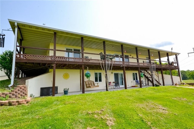 22920 Feaster Branch Rd, Warsaw, MO 64355 - back of property with stairway, a lawn, and a wooden deck