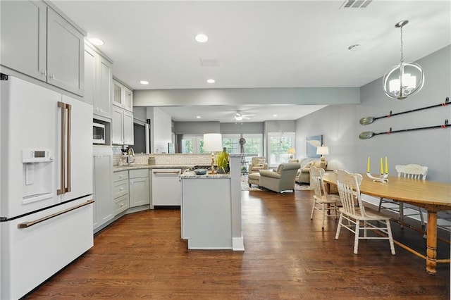 9 P St, Lees Summit, MO 64086 - kitchen with white appliances, a peninsula, ceiling fan, dark wood-style flooring, and recessed lighting