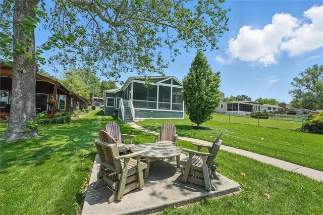 9 P St, Lees Summit, MO 64086 - view of grassy yard with a sunroom and a patio